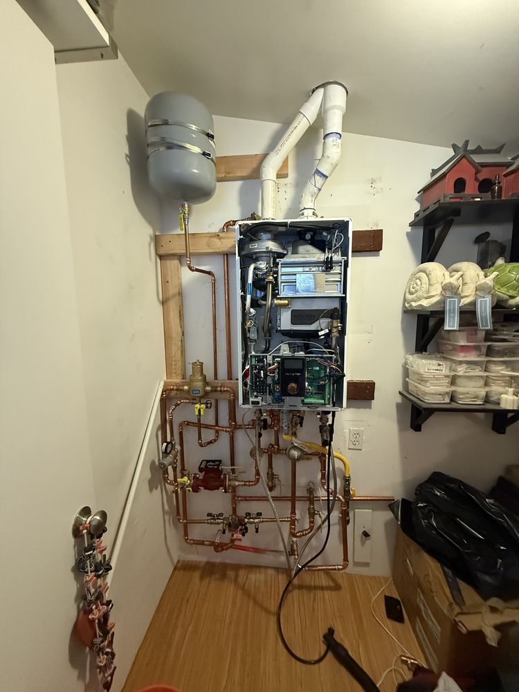 Tankless water heater installed with copper piping and expansion tank